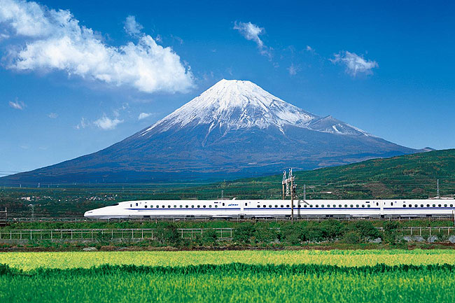 Shinkansen (bullet train) passing by Mount Fuji